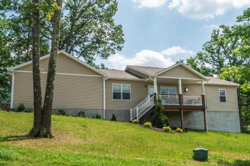 a home with a house with a tree at Happy Ours in McHenry