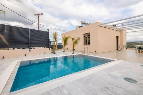 een villa met een zwembad en een huis bij Ostrako Luxury Villa 