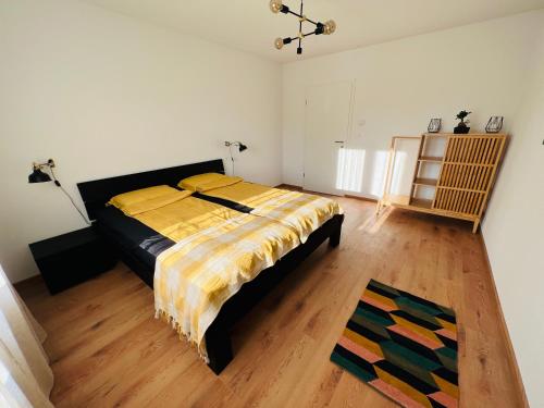 a bedroom with a bed and a wooden floor at Family M Apartments 4-5-6 in Kappel bei Olten