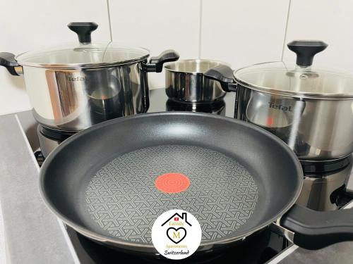 a pan on top of a stove with pots and pans at Family M Apartments 4-5-6 in Kappel bei Olten
