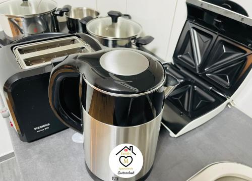 a coffee maker sitting on a counter next to a toaster at Family M Apartments 4-5-6 in Kappel bei Olten