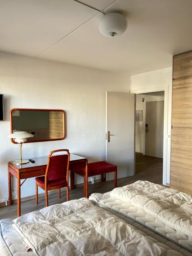 a bedroom with a bed and a desk and a table at Marienlyst Apartment in Helsingør
