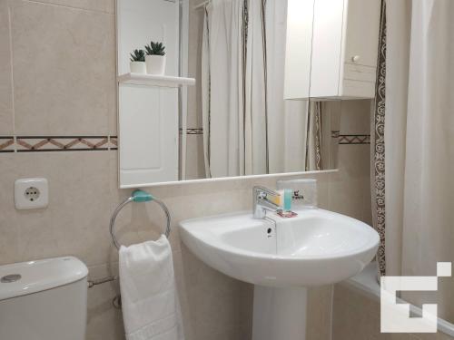 y baño con lavabo, aseo y espejo. en Apartamento Apolo XVII 22 - Grupo Turis, en Calpe