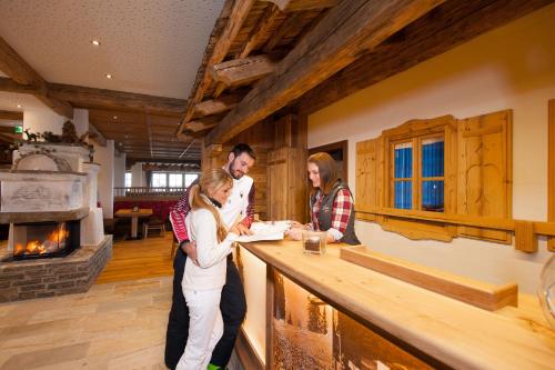 a group of people standing around a counter at Grossarler Panorama Stube in Grossarl