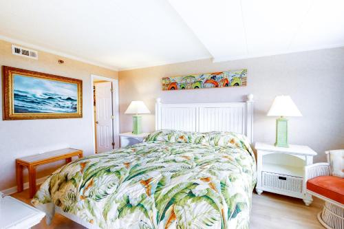 a bedroom with a bed with a colorful bedspread at Sandpiper Dunes 109 in Ocean City