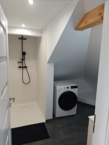 a laundry room with a washer and dryer in a room at Apartman Barbara in Lipany