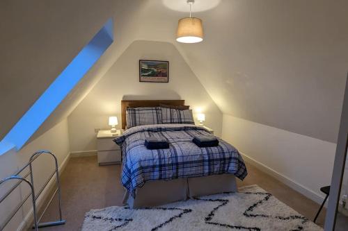 a bedroom with a bed in a attic at Quality rural retreat in Roch