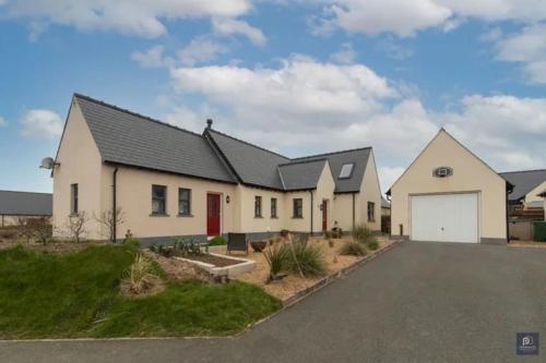 a row of houses with a driveway at Quality rural retreat in Roch