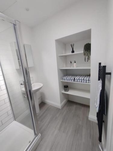 a white bathroom with a shower and a toilet at The Studio @ Cleeve Hill in Bath