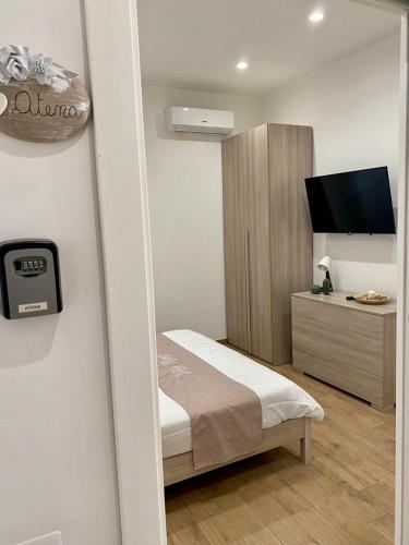 a bedroom with a bed and a tv in it at Villa Manto Bed and Breakfast - Torre Annunziata Pompei in Torre Annunziata