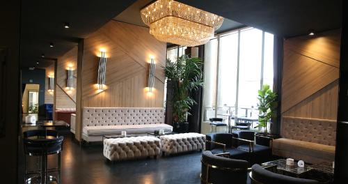 a lobby with a couch and a table and chairs at The Glamore Milano Duomo in Milan