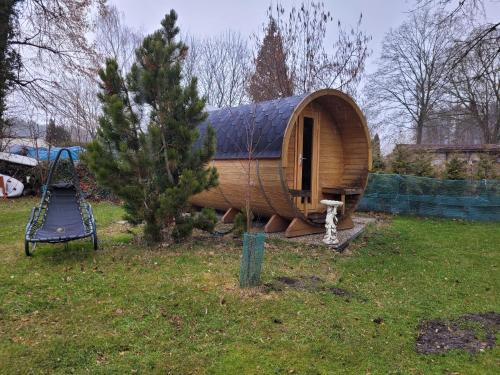 a small wooden boat sitting next to a playground at Ferienwohnungen am Krossinsee in Berlin