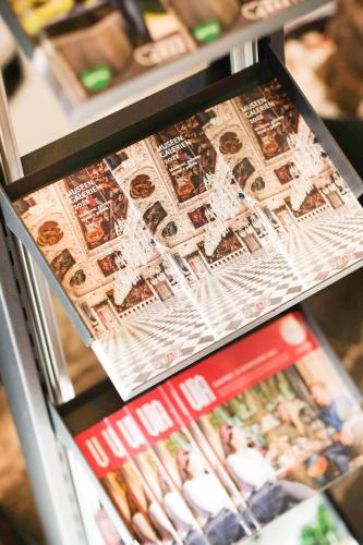 a refrigerator filled with lots of magazines at NED Hotel in Graz