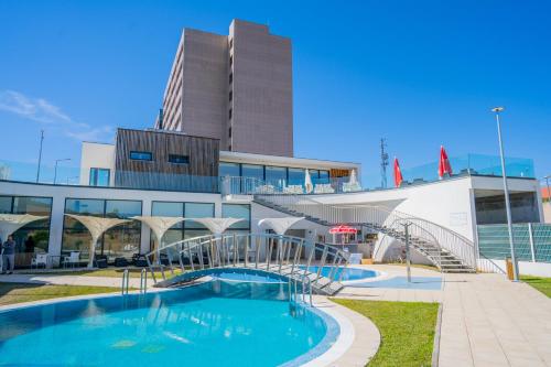 a large swimming pool in front of a building at Exe São Lázaro in Bragança