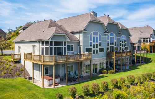 a large house with a porch and a deck at Vista Emmanuel in McHenry