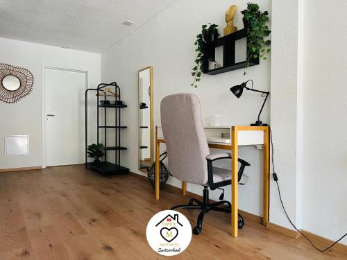 an office with a desk and a chair in a room at Family M Apartments 4-5-6 in Kappel bei Olten