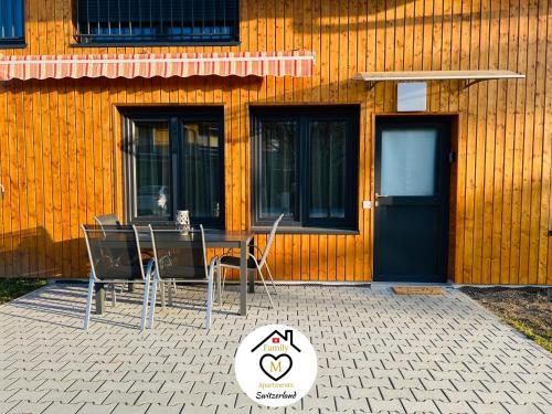 a table and chairs in front of a building at Family M Apartments 4-5-6 in Kappel bei Olten