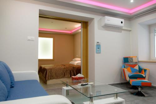 a living room with a bed and a glass table at Gogolapartman Tisza in Szeged