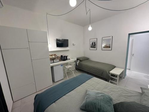 a bedroom with a bed and a desk in it at DI PASSAGGIO in Bari