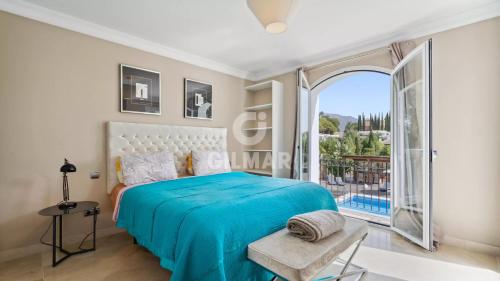 a bedroom with a bed and a large window at Villa Maracana in Marbella