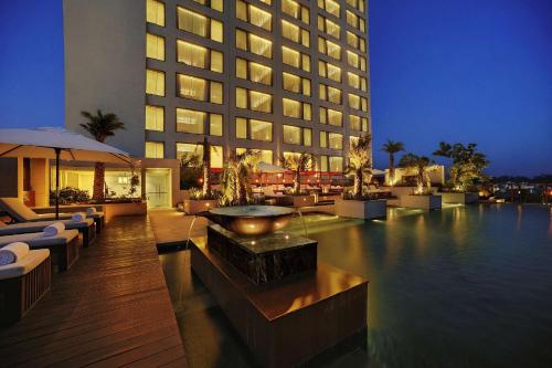 a hotel with a swimming pool and a building at Hyatt Regency Amritsar Hotel & Spa in Amritsar