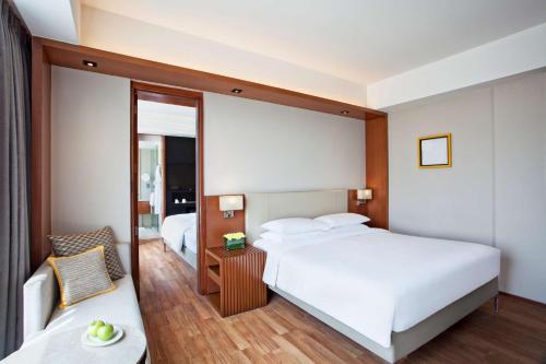a hotel room with two beds and a chair at Hyatt Regency Amritsar Hotel & Spa in Amritsar