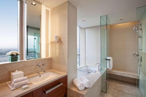 a bathroom with a sink and a glass shower at Hyatt Regency Amritsar in Amritsar