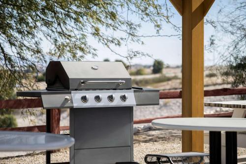 a grill with a picnic table and a table at Travelodge by Wyndham Yuma in Yuma