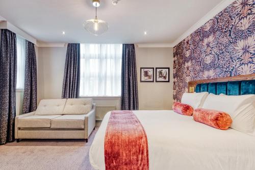 a hotel room with a bed and a couch at The Hand & Sceptre by Innkeeper's Collection in Southborough
