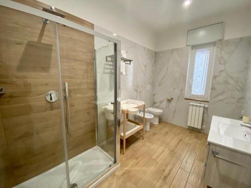 a bathroom with a shower and a toilet and a sink at Villa Manto Bed and Breakfast - Torre Annunziata Pompei in Torre Annunziata