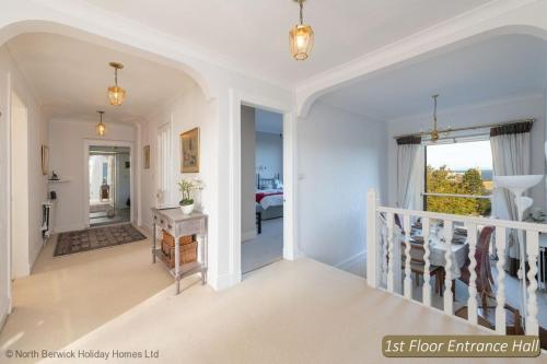 a hallway of a home with a staircase and a bedroom at Seascape in North Berwick