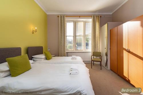 a hotel room with two beds and a window at Seascape in North Berwick