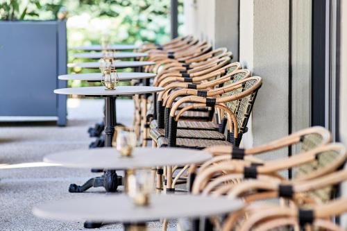 a row of tables and chairs in front of a building at La Maison in Adyliget