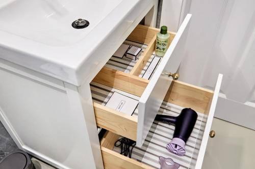 a drawer in a kitchen with a bottle of wine at La Maison 