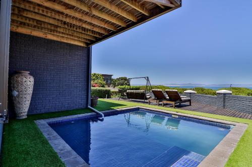 a swimming pool in the backyard of a house at The Whale's Tale Guesthouse in Hermanus