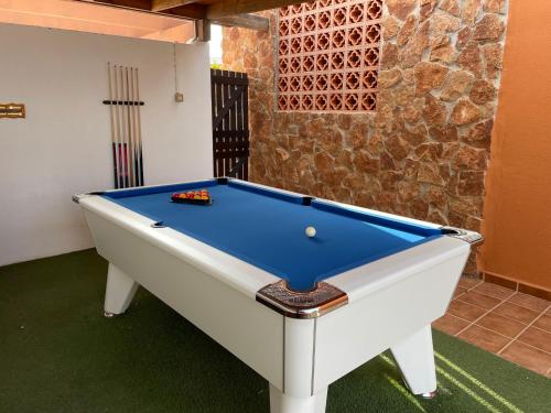 a pool table in a living room with at Casa Piedra, Luxury Family Front Line Golf, Hot Tub,Pool Table, 8 pers, Caleta de Fuste in Caleta De Fuste