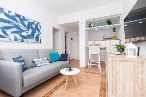 a living room with a couch and a kitchen at Home2Book Aloha Palm in Costa Calma