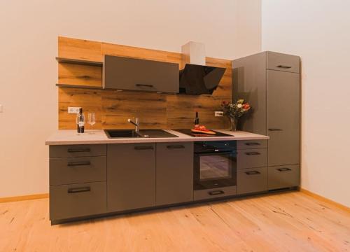 a kitchen with a sink and a refrigerator at Bienenstock in Seiffen