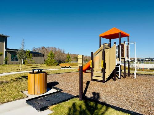 a playground with a slide in a park at Magical Themed Home - Disney 15 min in Kissimmee
