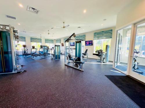 a gym with treadmills and machines in a room at Magical Themed Home - Disney 15 min in Kissimmee