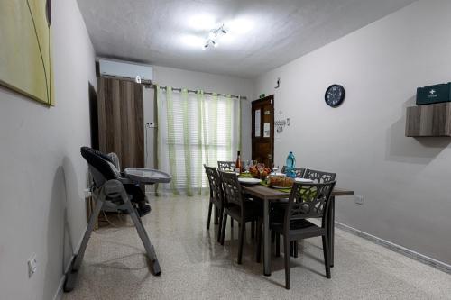 a dining room with a table and chairs at Seaside Flat with Scenic Country Views in Mellieħa