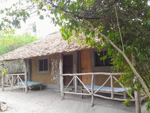 a small house with a thatched roof at Mida Creek Eco Camp in Watamu