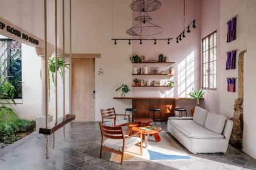 a living room with a couch and a table at Good Hotel Antigua in Antigua Guatemala