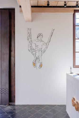 a drawing of a man hanging on a wall at Good Hotel Antigua in Antigua Guatemala