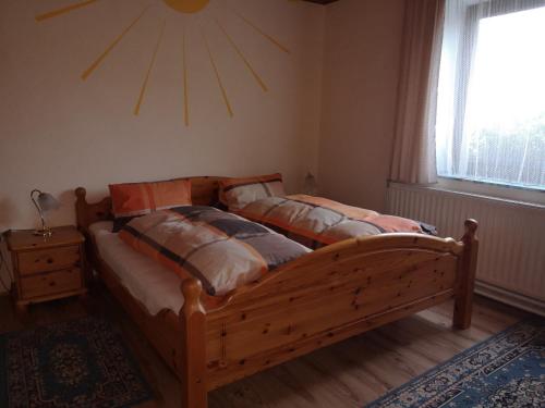 a bedroom with two beds and a sun on the wall at Stoagrawihof 