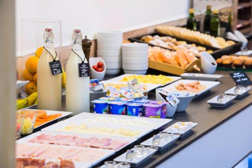 a buffet with many different types of food on a table at Hotel Elche Centro , affiliated by Melia in Elche