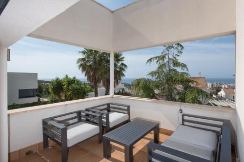a balcony with two chairs and a table at R144 Villa Sea view for 6 people in Calafell