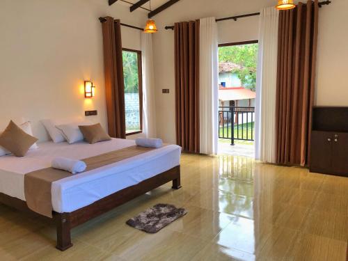 A bed or beds in a room at Finch Tangalle