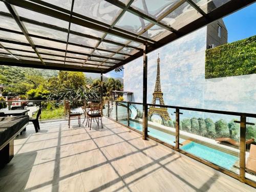 a balcony with a view of the eiffel tower at 8 Flags Private House and Hot Spring Pool in Los Baños