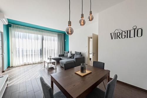 a living room with a table and a couch at Residence Virgilio Blue in Toscolano Maderno
